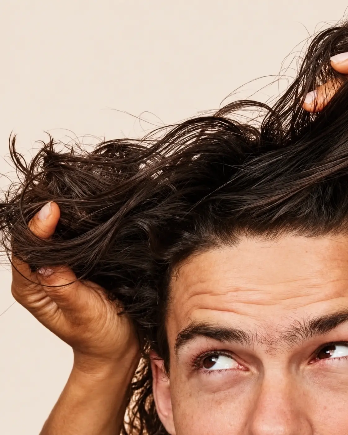 Man running his hands through his hair